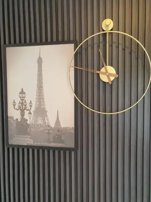 a clock on a wall with a picture of the eiffel tower at Casa Prinza Luxury Suite in Teresa