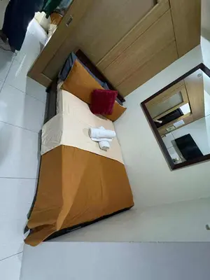 a large bed in a room with a mirror at 1br big cut 1524D Window Edsa Moa 2beds Queen size 1pullout 1extra mattress in Manila