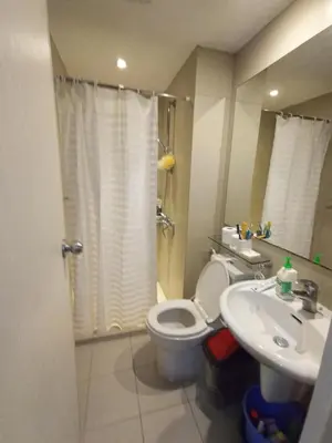 a bathroom with a toilet and a sink at azure beach front view in Manila