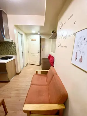 a living room with a couch and a kitchen at azure city view 2bedroom in Manila