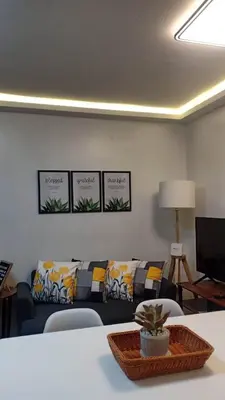 a living room with couches and a table at Your Home Away from Home in Manila