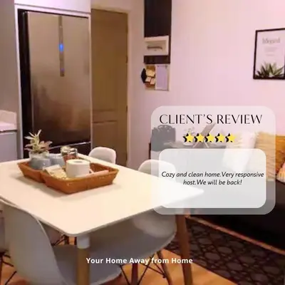 a dining room with a white table and chairs at Your Home Away from Home in Manila