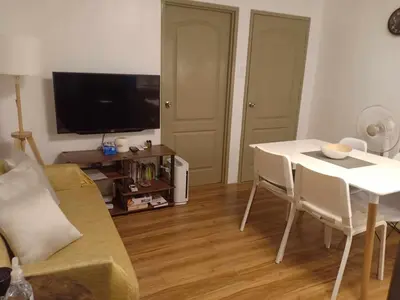 a living room with a couch and a table and a tv at Your Home Away from Home in Manila