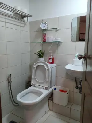 a bathroom with a toilet and a sink at Your Home Away from Home in Manila