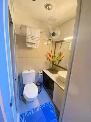 a small bathroom with a toilet and a sink at 1528-1br-1bed-1sofa bed 1pull out pool view with balcony in Manila