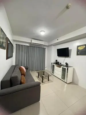 a living room with a couch and a tv at 1058-3br-10 beds 1 extra mattress-moa view with balcony in Manila