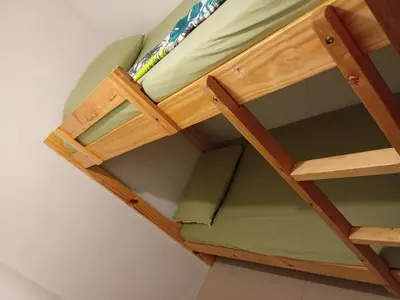 a wooden bunk bed in a room at 1058-3br-10 beds 1 extra mattress-moa view with balcony in Manila