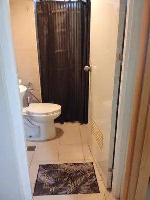 a bathroom with a toilet and a black shower at 1046-2Br 2bed 1extra matress pool view with balcony in Manila