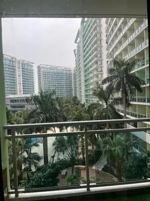 a view of a city with palm trees and buildings at 1 bedroom azure beachview 6 in Manila