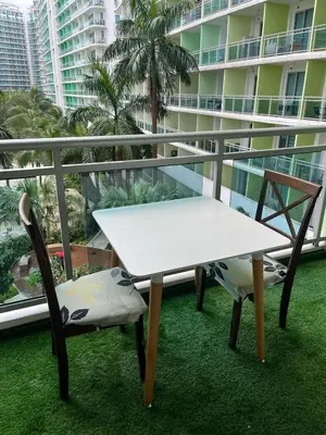 a white table and two chairs on a balcony at 1 bedroom azure beachview 6 in Manila