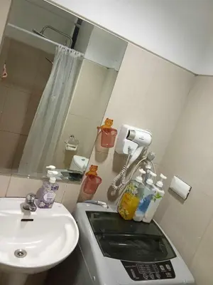 a bathroom with a sink and a mirror at 241-1br -1bed 1 extra mattress in Manila