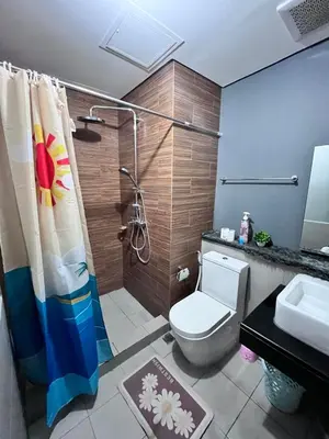 a bathroom with a shower and a toilet and a sink at Bayview near CCP, PICC, Airport, MOA, Okada at Radiance in Manila