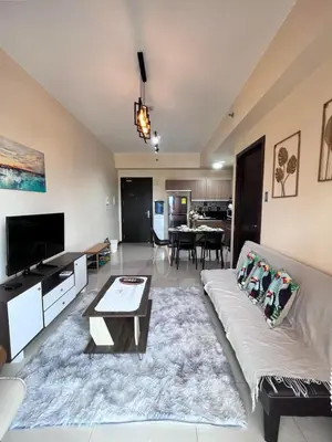 a living room with a couch and a table at Bayview near CCP, PICC, Airport, MOA, Okada at Radiance in Manila