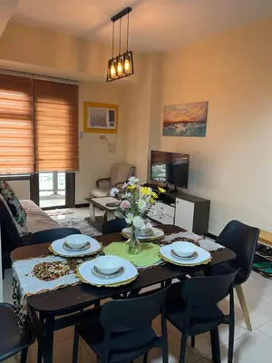 a living room with a table and chairs at Bayview near CCP, PICC, Airport, MOA, Okada at Radiance in Manila