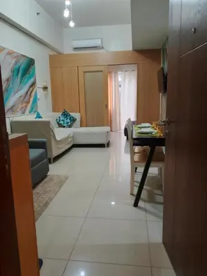 a living room with a couch and a table at 101-2Br-1bed quenn-1single-1-pullout 2 sofa 2-cr pool view with balcony in Manila