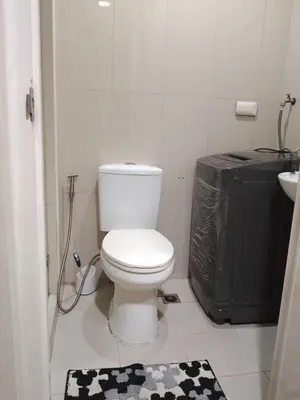 a bathroom with a toilet and a black and white rug at 349-1br 1bed quenn 1sofa bed 2extra mattress moa view with balcony in Manila