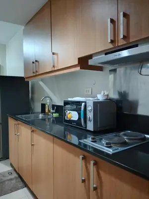 a kitchen with a microwave and a stove top oven at 349-1br 1bed quenn 1sofa bed 2extra mattress moa view with balcony in Manila