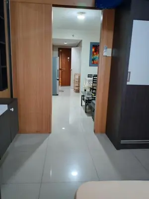 an empty hallway with a kitchen and a living room at 349-1br 1bed quenn 1sofa bed 2extra mattress moa view with balcony in Manila