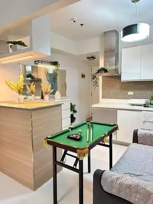 a living room with a ping pong table in a kitchen at SM Bicutan MNL in Manila