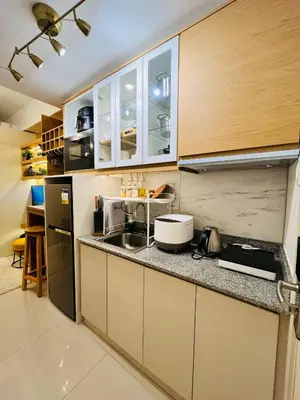 a kitchen with a sink and a counter top at SolAzur Staycation SMDC South Residences Las Piñas with 100MBPS Wifi &NETFLIX &BAR STATION &CITY LIGHTS VIEW in Manila