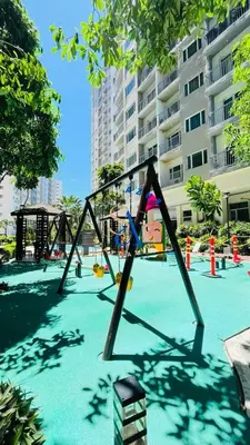 an empty playground in a park with a building at SolAzur Staycation SMDC South Residences Las Piñas with 100MBPS Wifi &NETFLIX &BAR STATION &CITY LIGHTS VIEW in Manila