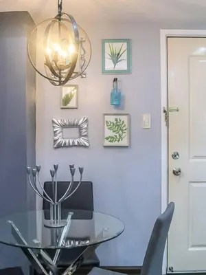 a dining room with a glass table and a chandelier at BGC Urban Studio Prime Spot, Walk to Everything in Manila