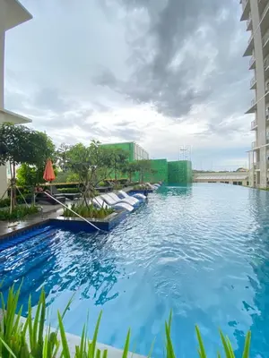 a pool at a hotel with blue water at A1 Suite in McKinley in Manila