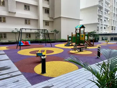 a playground in front of a building with swings at A1 Suite in McKinley in Manila