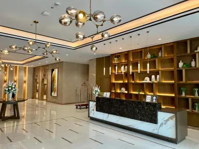 a lobby with a reception desk in a building at A1 Suite in McKinley in Manila