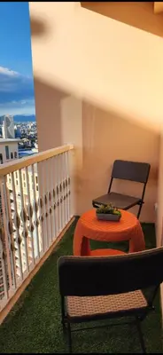a table and a chair on a balcony at The Venice Luxury Residences Condominium 28B Bellini, McKinley Hill, Taguig City, Philippines in Manila