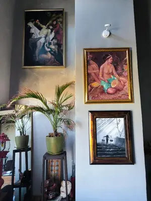 three paintings hanging on a wall with plants on it at Unit 820 Zamora sky tower in Manila