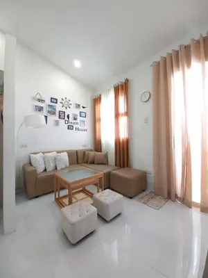 a living room with a couch and a table at Tanza Cavite Staycation Condo Loft in Tanza