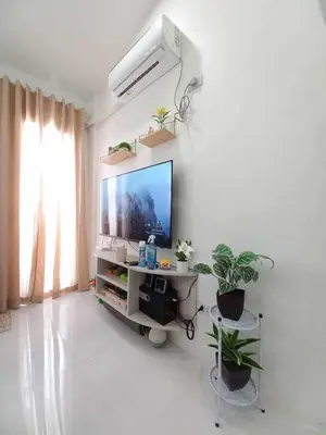 a living room with a flat screen tv on a wall at Tanza Cavite Staycation Condo Loft in Tanza