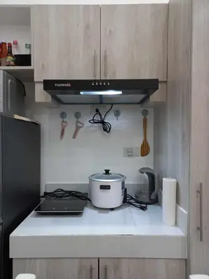a kitchen with a stove and a pot on a counter at Tanza Cavite Staycation Condo Loft in Tanza