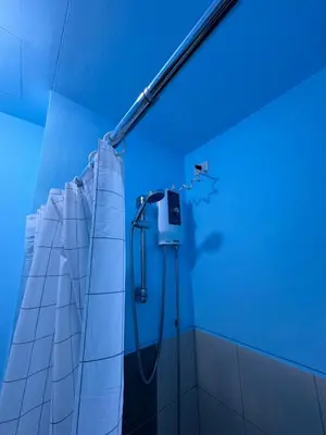 a bathroom with a shower with blue lights at The Cozy Palette Manila in Manila