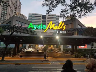 aania maxis sign on a building in a city at The Cozy Palette Manila in Manila