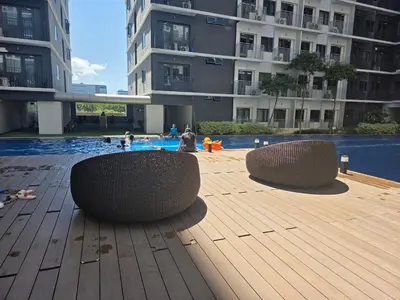 a swimming pool with two benches in a building at Aloha Escape for Coffee Lovers in Manila