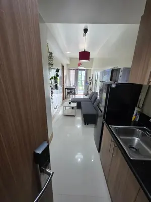 a kitchen with a sink and a living room at Aloha Escape for Coffee Lovers in Manila