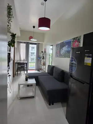 a living room with a couch and a refrigerator at Aloha Escape for Coffee Lovers in Manila