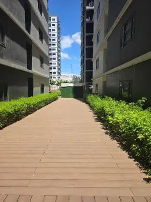 an empty sidewalk between two tall buildings at Aloha Escape for Coffee Lovers in Manila