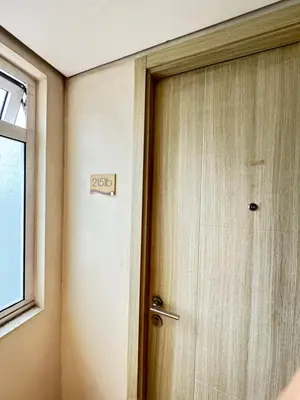 a door with a sign on it next to a window at Breeze Deluxe Unit Roxas blvd in Manila