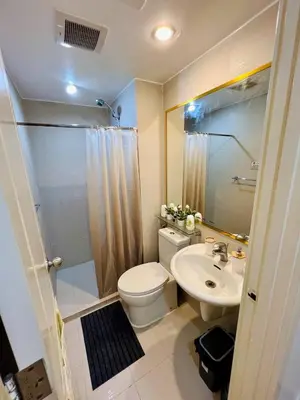 a bathroom with a toilet and a sink and a shower at AZURE STAYCATION by TALA in Manila