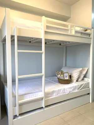 a room with bunk beds with a basket on top at Amari Staycation - Alabang in Manila