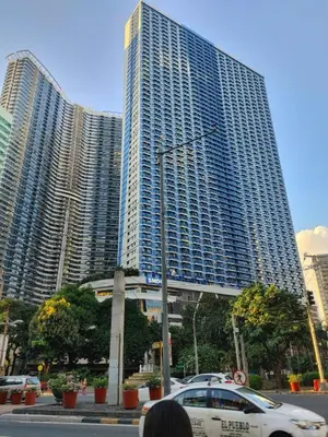 a car parked in front of two tall buildings at Casa Mexico at Air Residences Makati in Manila