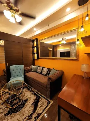 a living room with a couch and a table at Casa Mexico at Air Residences Makati in Manila