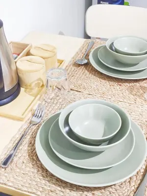 a table set with plates and utensils on a table at The Crash Pad Soho Central in Manila