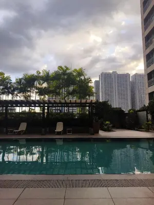 a swimming pool in a city with tall buildings at The Crash Pad Soho Central in Manila