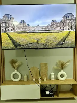 a television screen with a picture of a large building at 2 Bedroom Unit at Central Makati in Manila