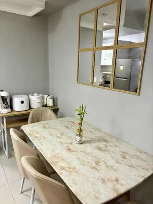 a kitchen with a table with chairs and a mirror at 2 Bedroom Unit at Central Makati in Manila