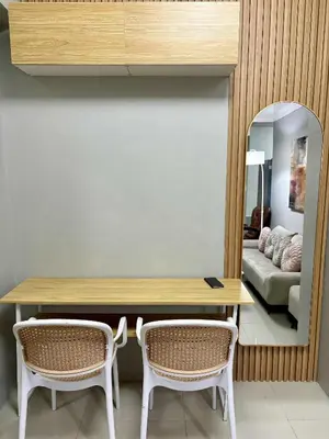 a dining room with a table and two chairs at 2 Bedroom Unit at Central Makati in Manila